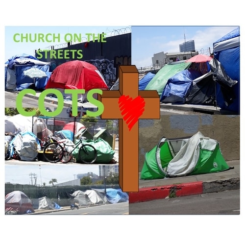 A cross in-front of two tents and sleeping bags.