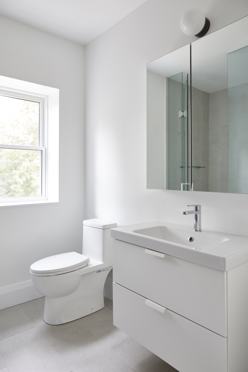 Annex Duplex: Set on a classic Annex streetscape, this property called for two matching yet distinct homes within one build, each with its own light-filled kitchen finished in a mix of flat-panel white and warm rift oak cabinetry