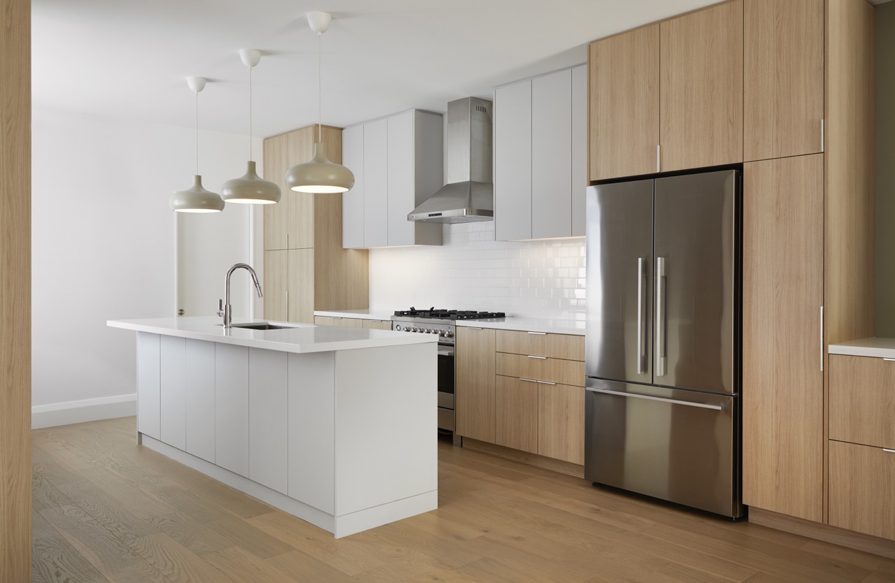 Annex Duplex: Set on a classic Annex streetscape, this property called for two matching yet distinct homes within one build, each with its own light-filled kitchen finished in a mix of flat-panel white and warm rift oak cabinetry