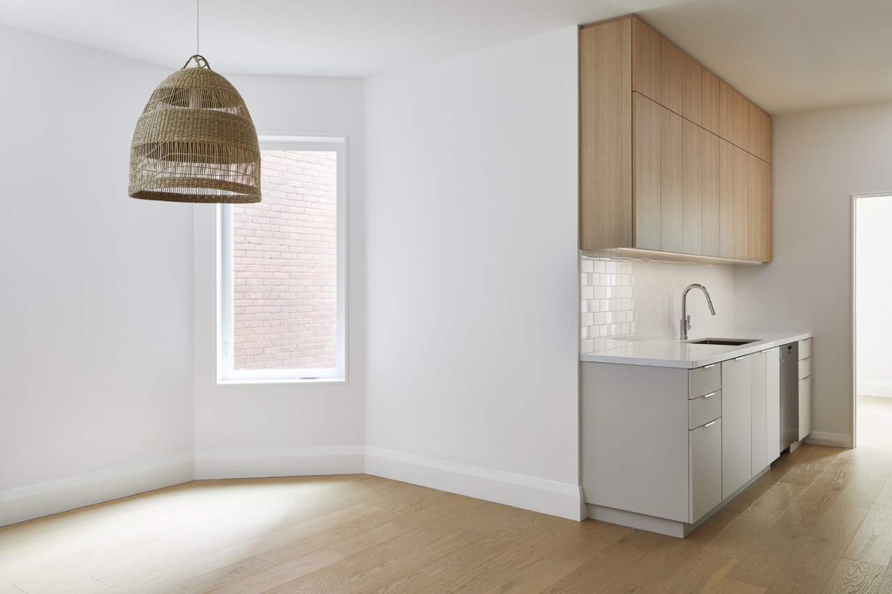 Annex Duplex: Set on a classic Annex streetscape, this property called for two matching yet distinct homes within one build, each with its own light-filled kitchen finished in a mix of flat-panel white and warm rift oak cabinetry