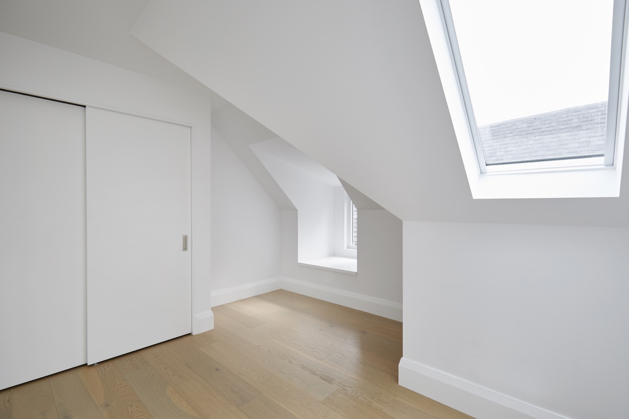Annex Duplex: Set on a classic Annex streetscape, this property called for two matching yet distinct homes within one build, each with its own light-filled kitchen finished in a mix of flat-panel white and warm rift oak cabinetry
