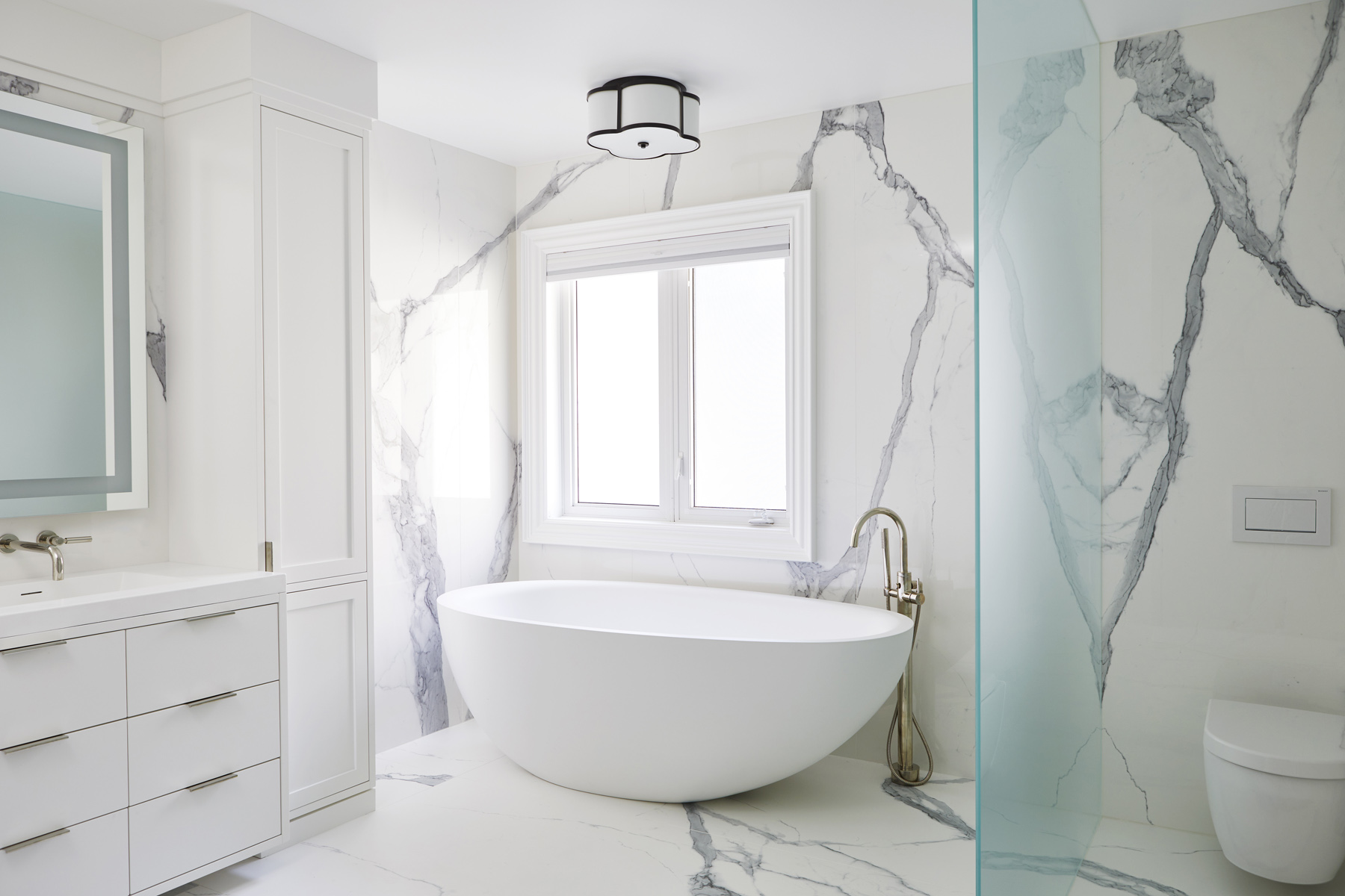 Humber Valley Village: The powder room cleverly utilized leftover marble from the kitchen to create a custom floating vanity for the powder to great effect