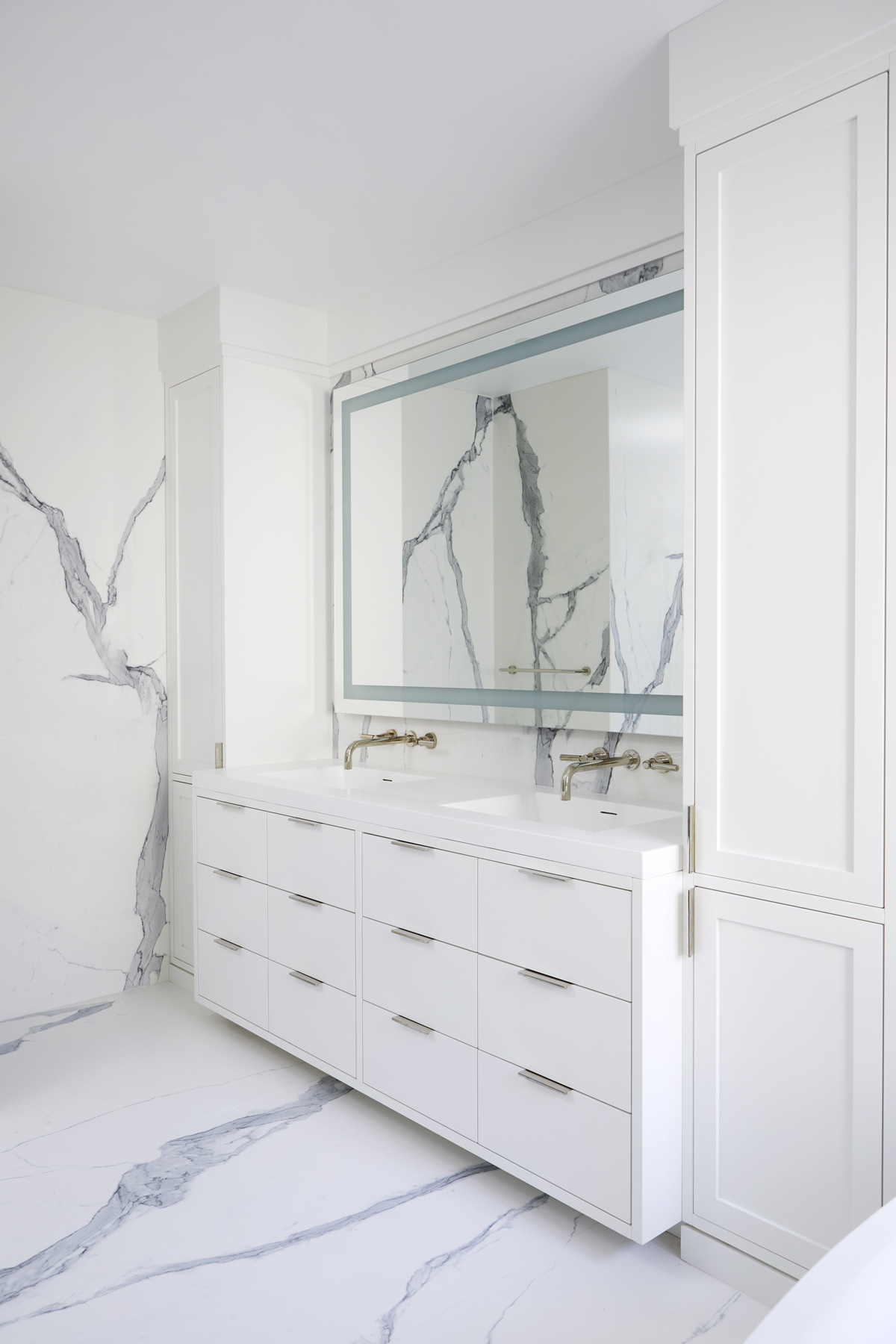 Humber Valley Village: From floor to ceiling book matched Statuario slabs of Laminam, polished nickel hardware, oversized soaker tub, integrated LED mirror, floating shower bench, linear drain, and frameless glass partitions this ensuite spared no…