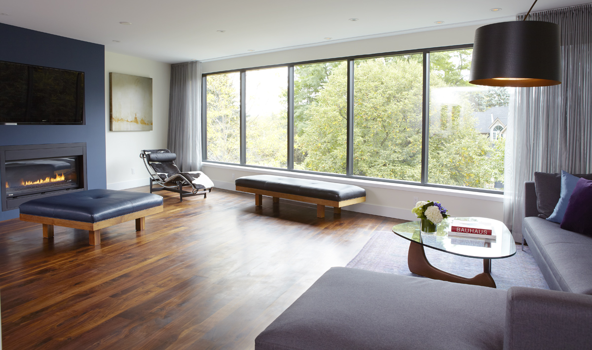 West Toronto: Challenges included removing an elevator, leveling and resurfacing over 3000sq/ft of flat roof, replacing all windows including the addition of a 20 ft curtain window, raising the ceilings and installing solid walnut plank flooring