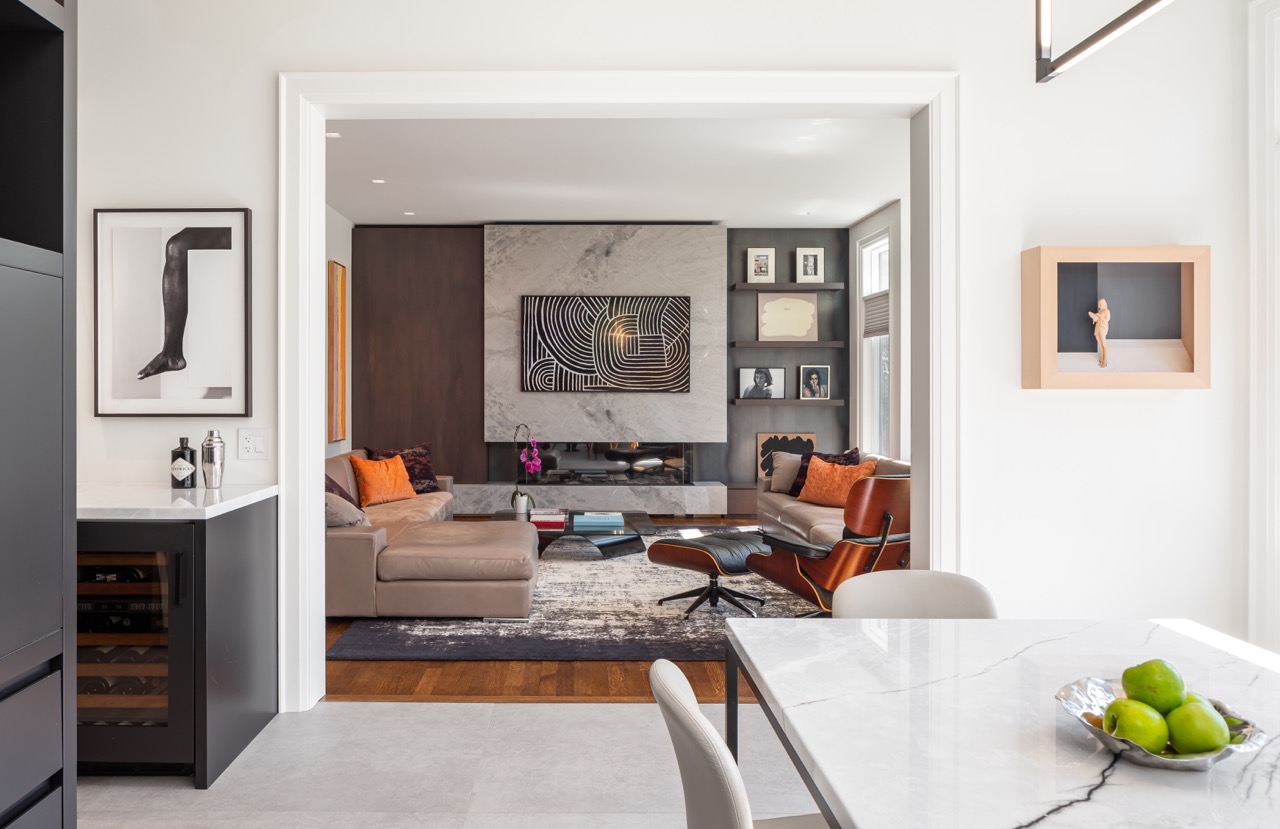 Stylish South Hill: Rich walnut cabinetry wraps the room floor to ceiling, framed by full-height steel windows and doors that flood the space with light