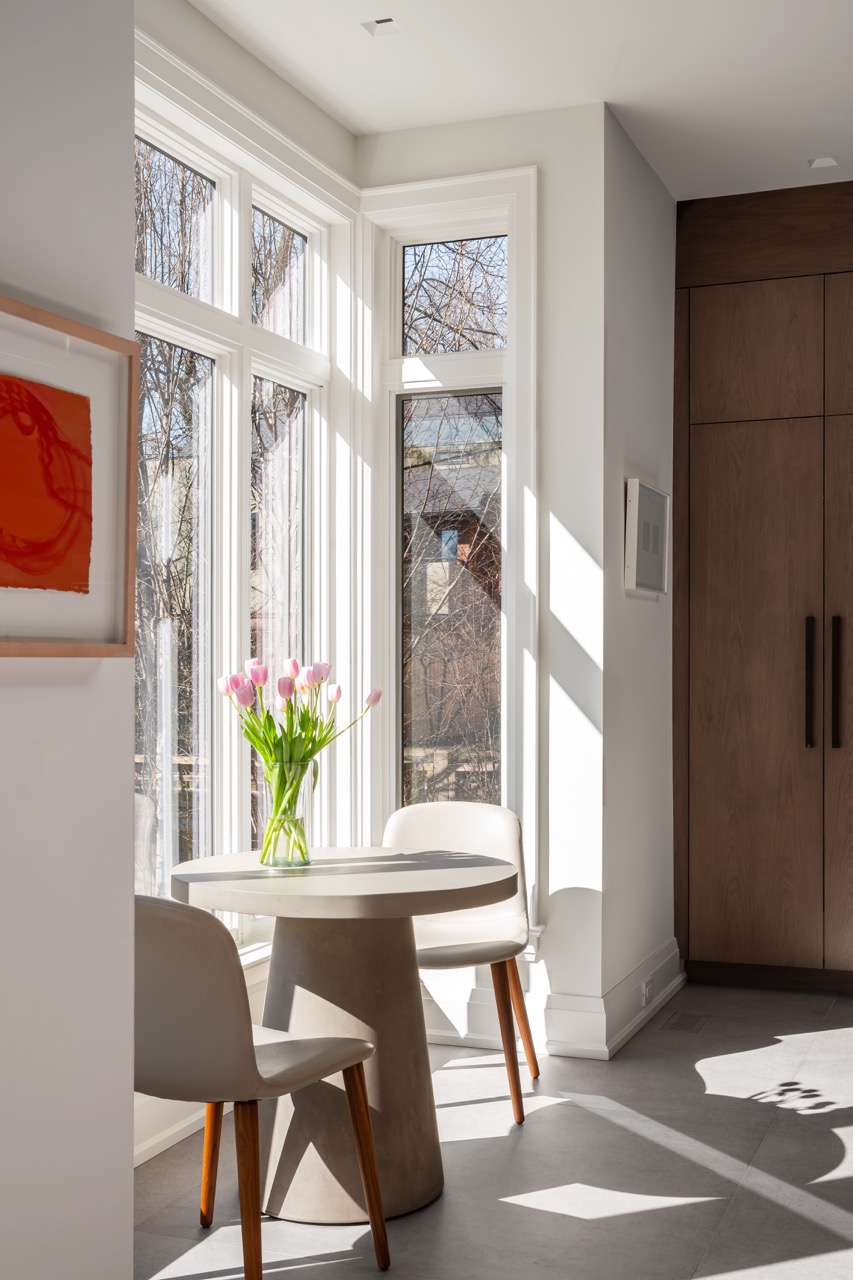 Stylish South Hill: Rich walnut cabinetry wraps the room floor to ceiling, framed by full-height steel windows and doors that flood the space with light