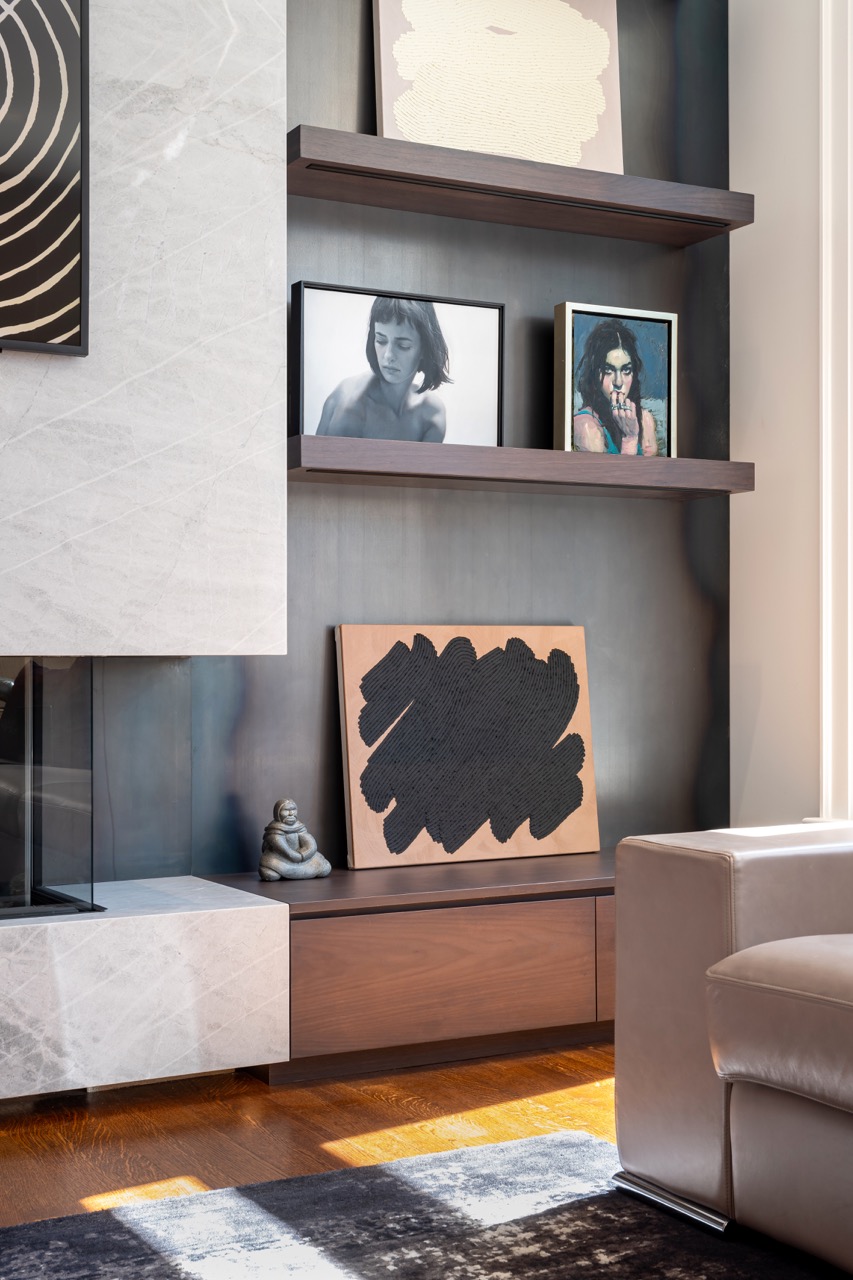 Stylish South Hill: Pops of citrus-toned art play off the warm wood tones, while polished stone flooring keeps the whole space grounded