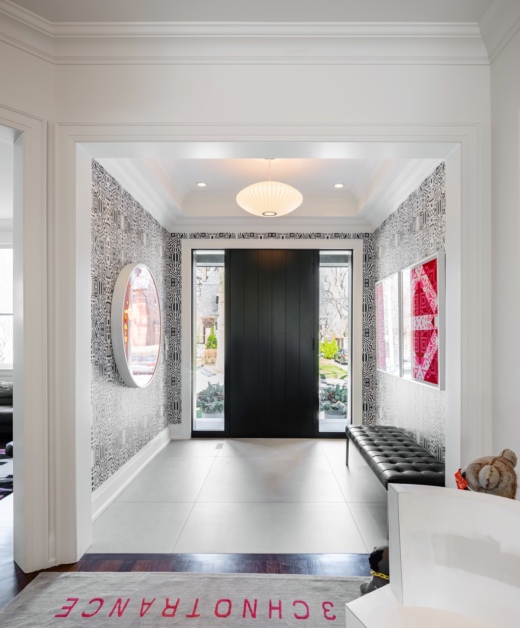 Stylish South Hill: Rich walnut cabinetry wraps the room floor to ceiling, framed by full-height steel windows and doors that flood the space with light