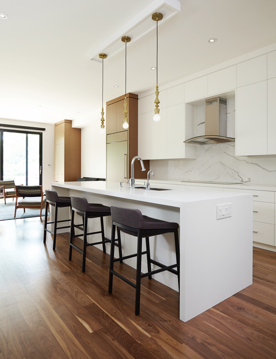 North Toronto Revived: Warm walnut floors and well thought out custom millwork serve to delineate the main floor areas and allow for ample storage space