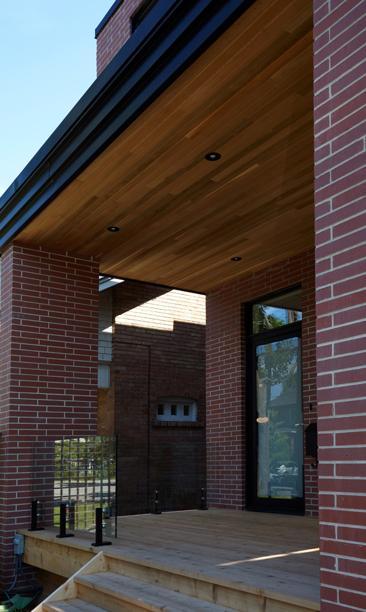 North Toronto Revived: Frameless glass stair guards, stainless steel handrails and door hardware, and natural stone tile selections accent the interior - while cedar, red brick and custom standing-seam black metal cladding are all integrated into…