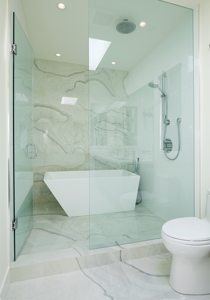 North Toronto Revived: Frameless glass stair guards, stainless steel handrails and door hardware, and natural stone tile selections accent the interior - while cedar, red brick and custom standing-seam black metal cladding are all integrated into…