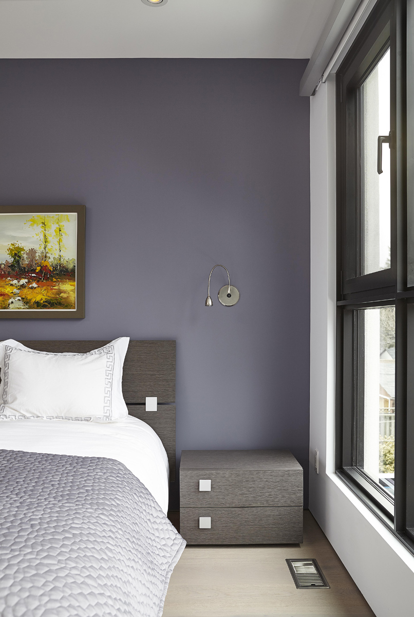 Swansea: The double height wall running up through the mono-beam staircase is now adorned with art, family photos and mementos from their love of travel