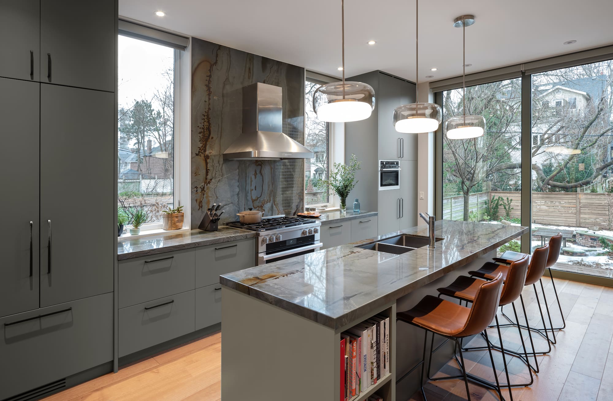 Astounding Annex: Behind its classic Annex exterior, this home now centers on a sage green kitchen finished with a dramatic full-height natural stone backsplash, its rust-and-teal veining picking up the warmth of the surrounding oak flooring