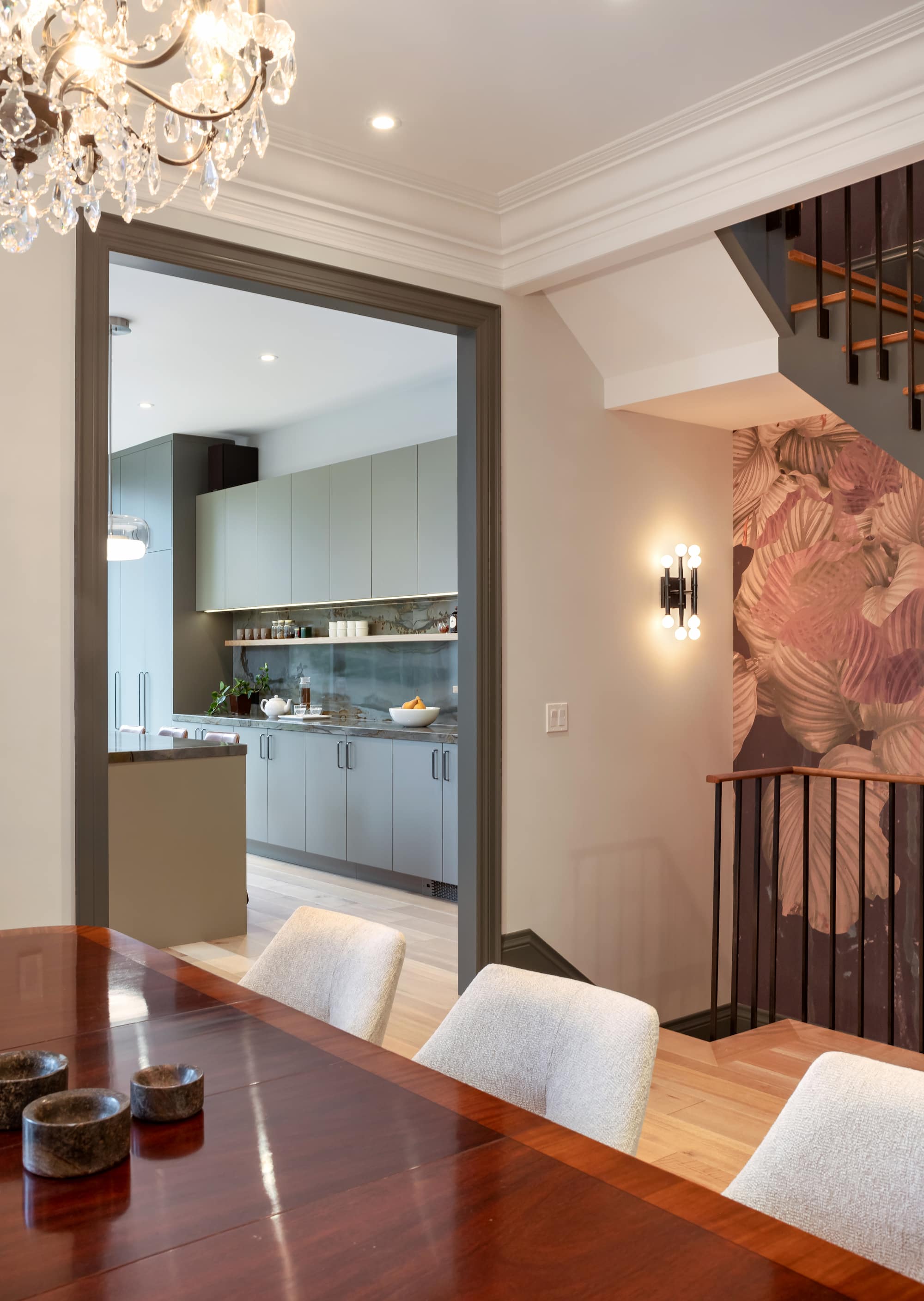 Astounding Annex: Open wood shelving, leather counter stools, and glass globe pendants keep the space feeling collected rather than showroom-new
