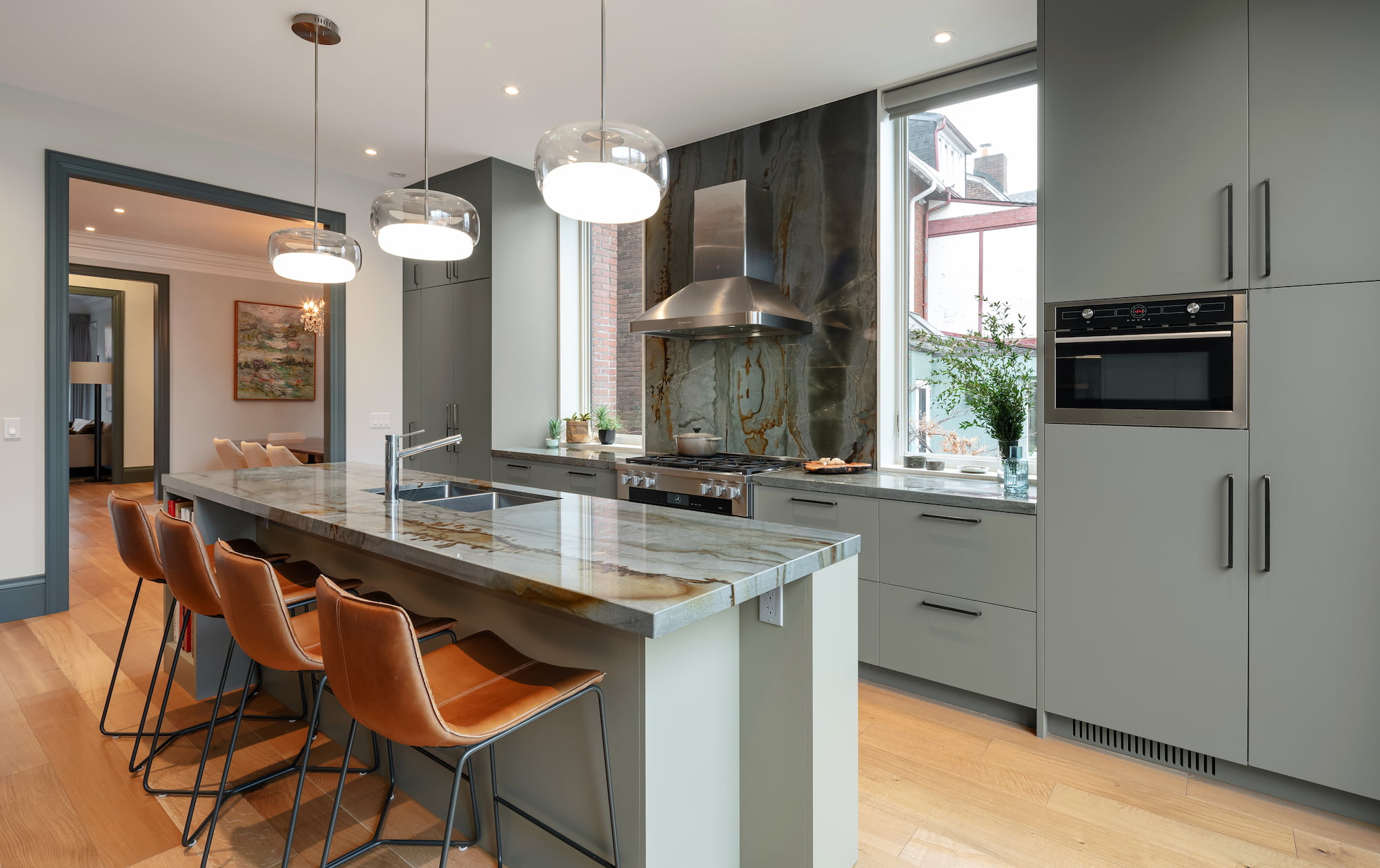 Astounding Annex: Behind its classic Annex exterior, this home now centers on a sage green kitchen finished with a dramatic full-height natural stone backsplash, its rust-and-teal veining picking up the warmth of the surrounding oak flooring