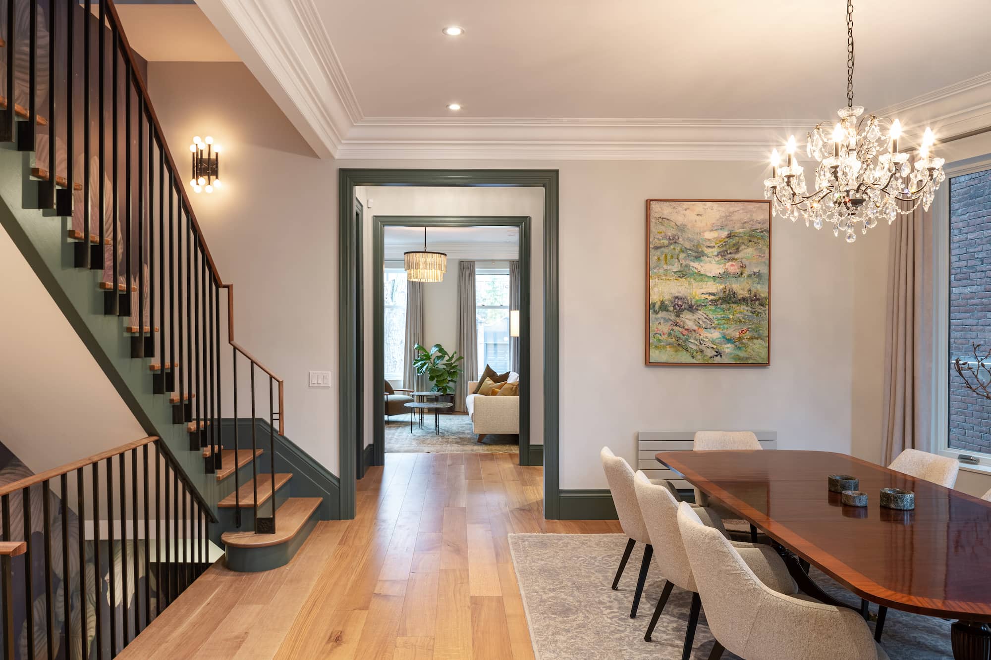 Astounding Annex: Behind its classic Annex exterior, this home now centers on a sage green kitchen finished with a dramatic full-height natural stone backsplash, its rust-and-teal veining picking up the warmth of the surrounding oak flooring