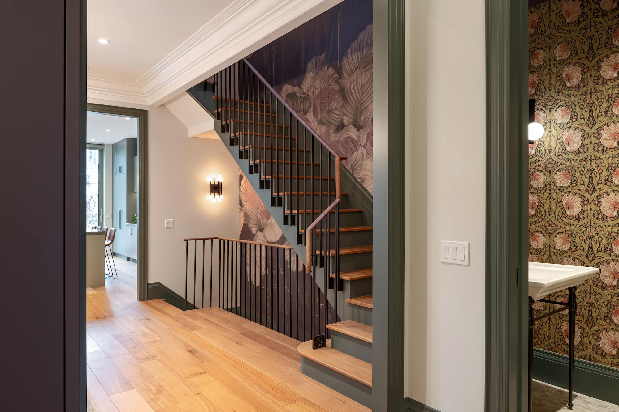 Astounding Annex: Open wood shelving, leather counter stools, and glass globe pendants keep the space feeling collected rather than showroom-new
