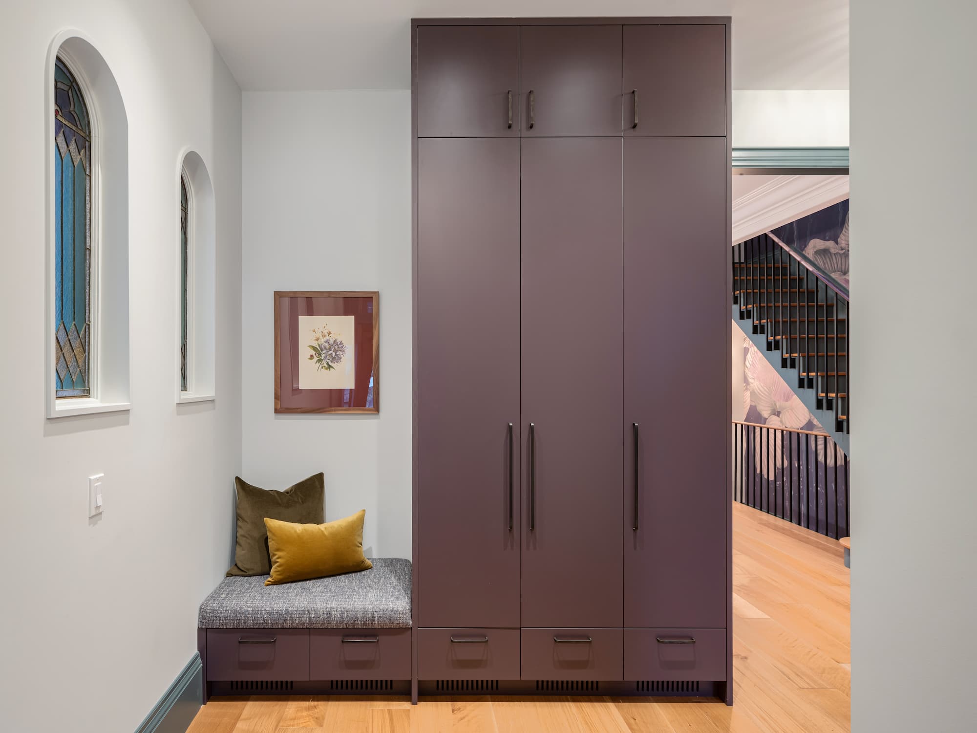 Astounding Annex: A hand-painted floral mural lines the stairwell in a rich rust and blush palette, and deep green door trim and crown moulding carry a sense of old-world detail through the rest of the main floor