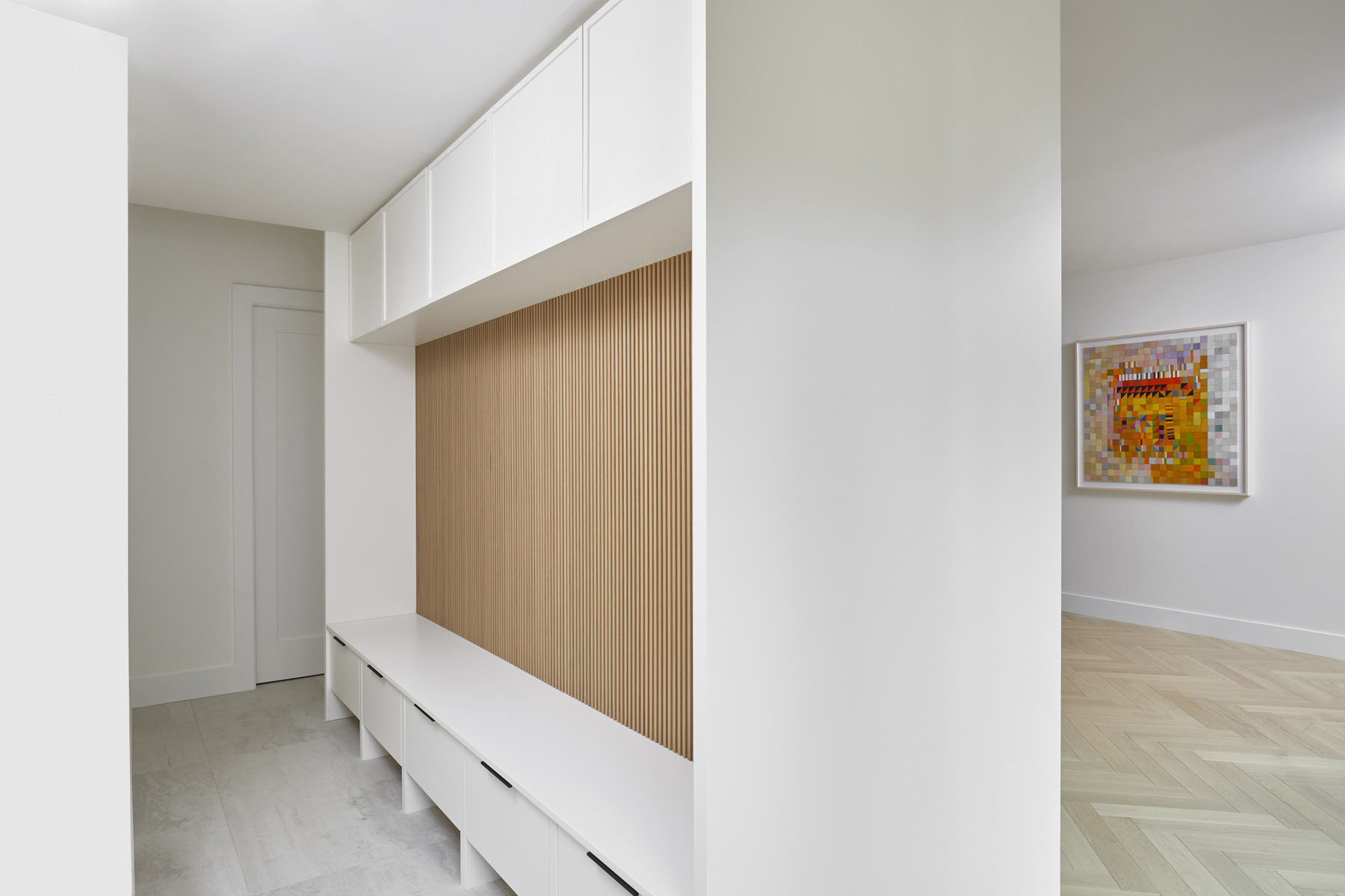 Roncesvalles Remodel: It features a curved leather banquette nestled in the bay window, floor to ceiling millwork with a full pantry, integrated appliances, panel ready Sub Zero and expansive storage