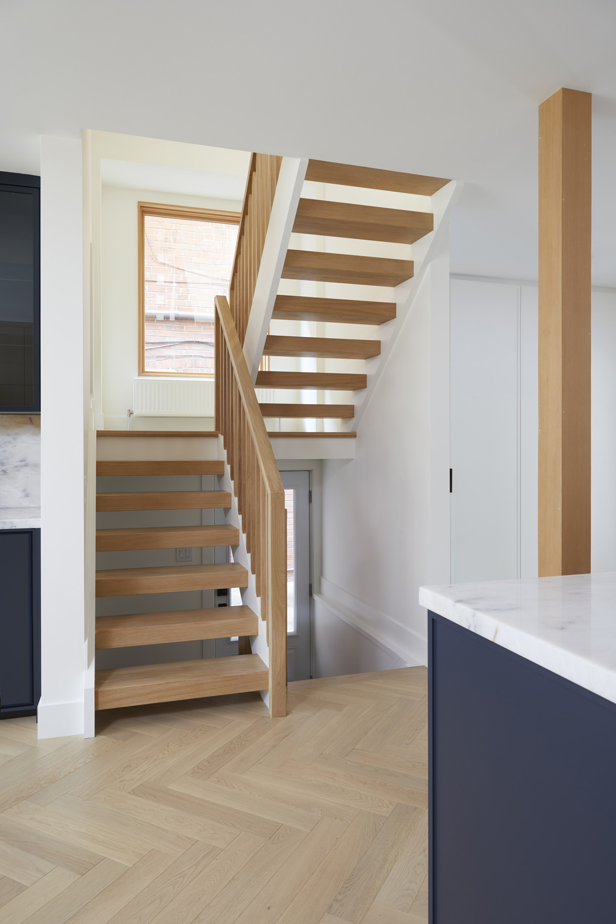 Roncesvalles Remodel: Now reclaimed as a single family home, the dwelling includes 4 bedrooms, 3 baths, a main floor mud room and an open, airy yoga retreat on the third floor with walkout deck and sweeping views of the backyard