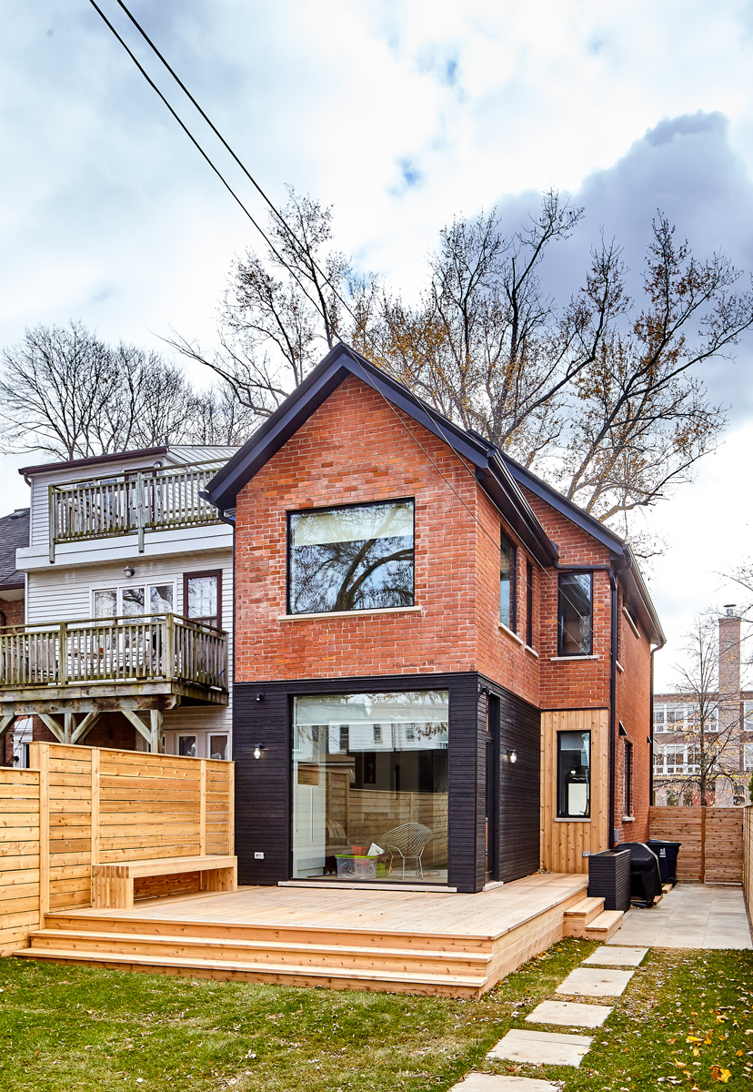 Roncesvalles Reno: The ground floor opens onto a cozy built-in banquette with a wood ceiling that wraps down one wall, adding warmth and richness to a clean interior