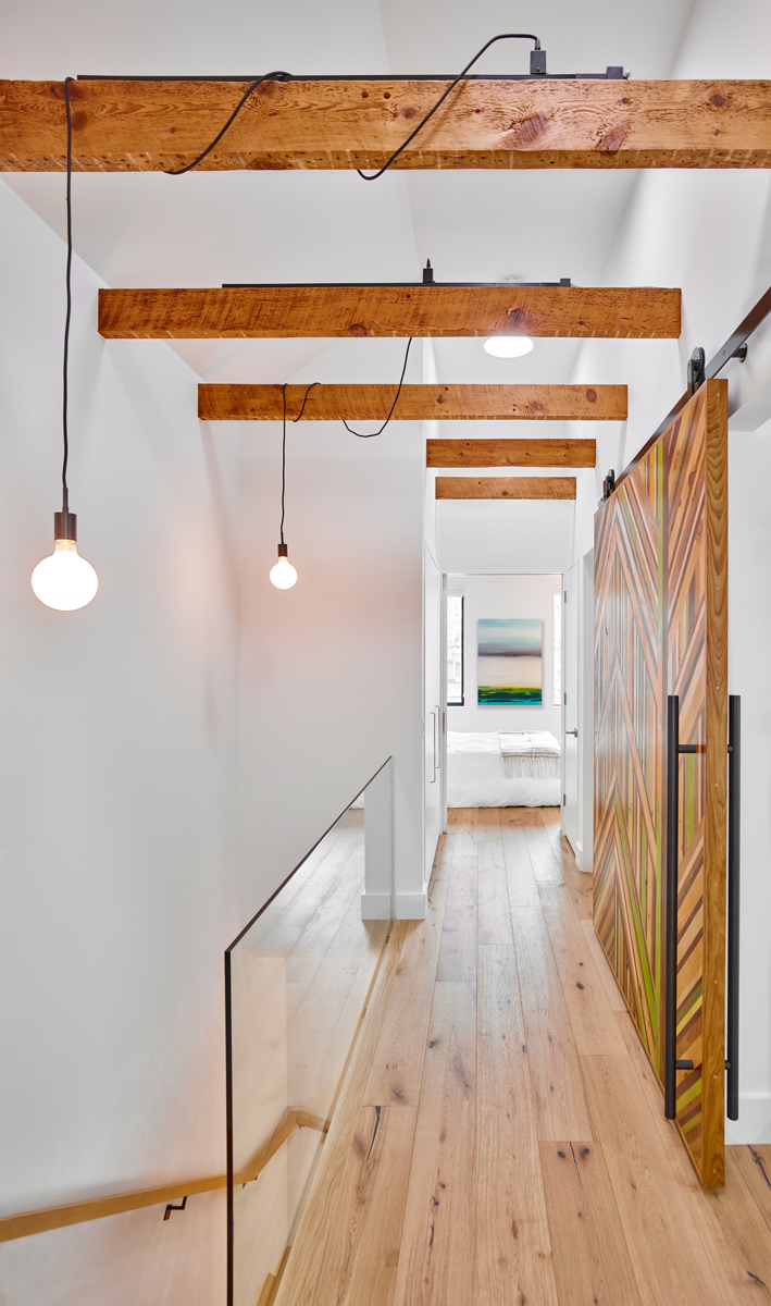 Roncesvalles Reno: A custom made barn door that repurposes scraps of reclaimed wood makes a bold statement on the 2nd floor, enclosing a small den space off the multi-use corridor, and in the basement, a custom built in shelving unit uses rough,…