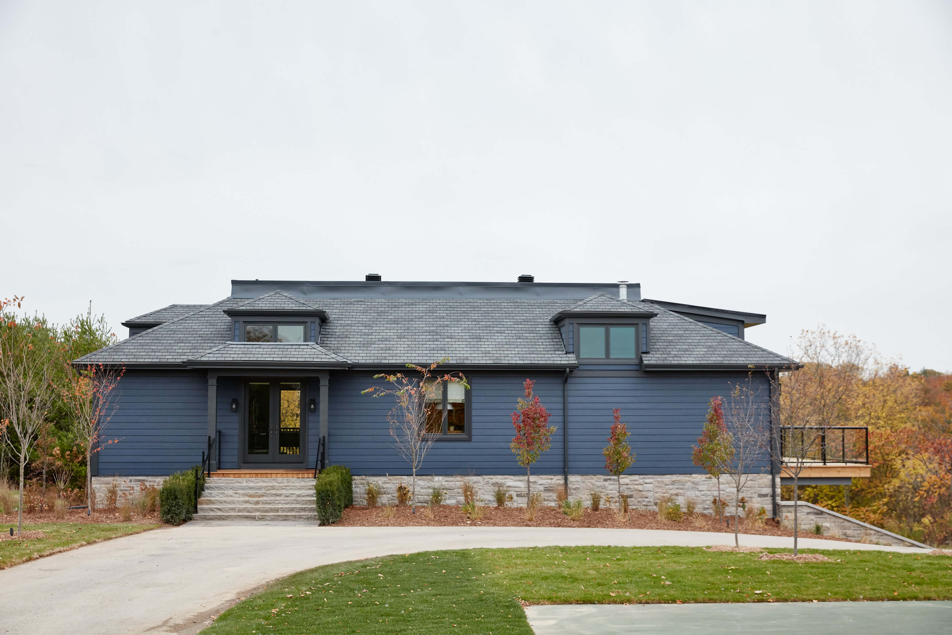 Country Retreat: The dark teal kitchen receives an injection of light from a thoughtfully-appointed skylight; a dining room with vaulted ceilings and bead board walls add a rustic feel