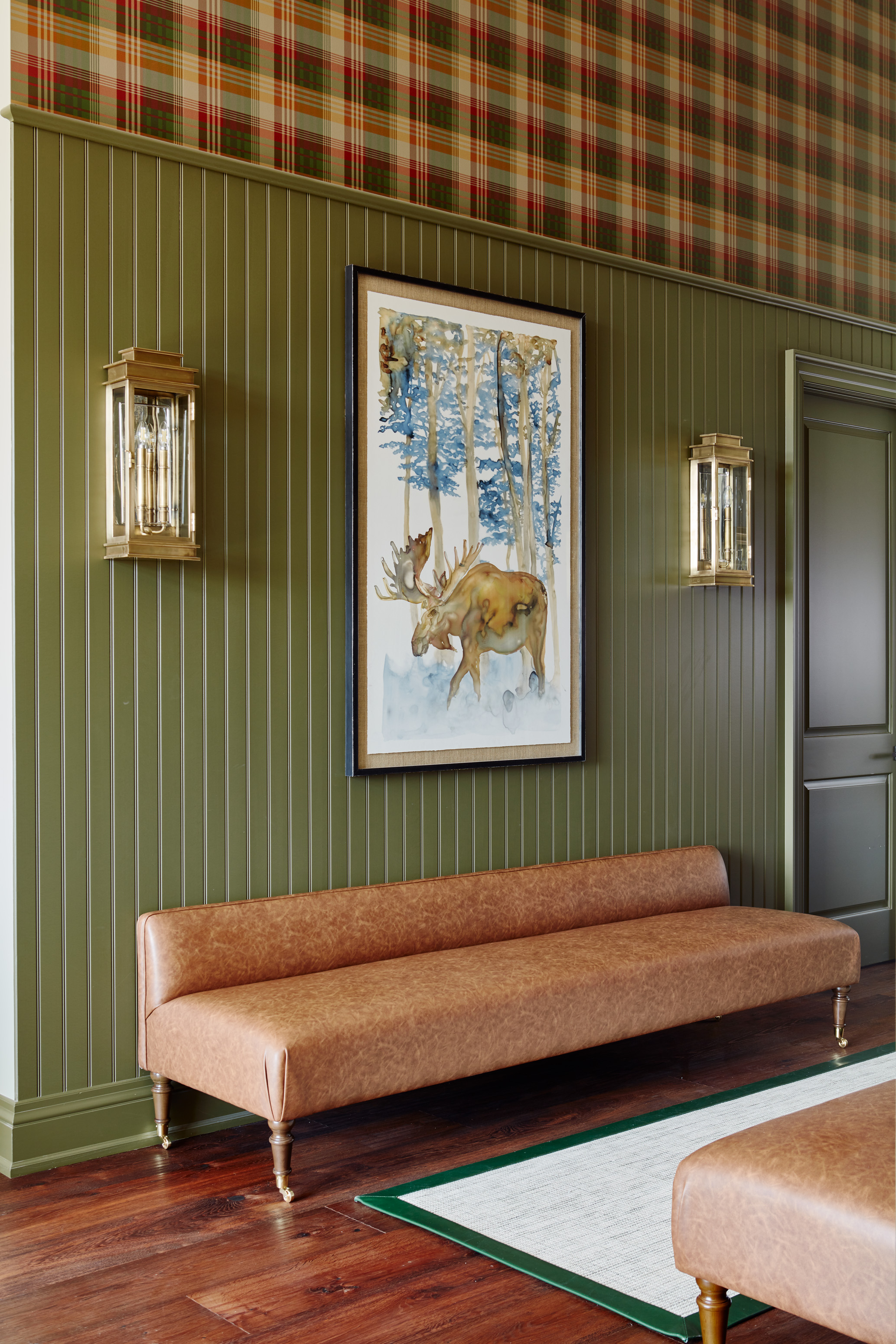 Country Retreat: Antlers, antique framed mirrors and plaid trim accentuates the high ceilings