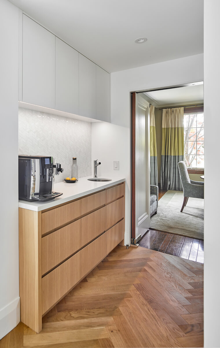 Beautiful Baby Point: The kitchen's crisp, clean palette is the perfect neutral foil for the handmade backsplash, and generous floor-to-ceiling windows provide a vista to the lush green yard and onto the Humber ravine