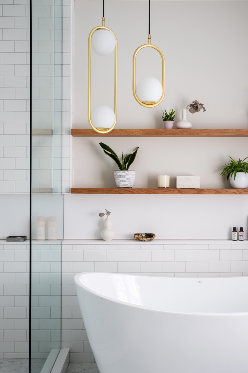 Rusholme Restored: Upstairs, statement botanical wallpaper anchors two bathrooms finished with white oak vanities, farmhouse sinks, and brass fixtures, while a third bath keeps things bright with subway tile, a freestanding oval tub, and floating…