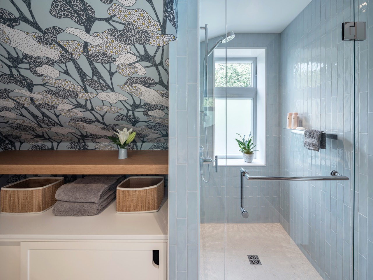 Rusholme Restored: The adjoining kitchen goes moody with navy blue cabinetry, brass dome pendants, and a waterfall island with seating for the whole family