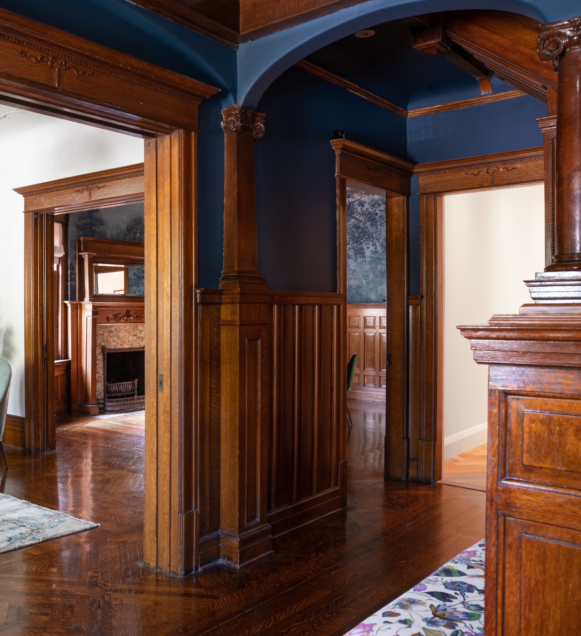 Rusholme Restored: Upstairs, statement botanical wallpaper anchors two bathrooms finished with white oak vanities, farmhouse sinks, and brass fixtures, while a third bath keeps things bright with subway tile, a freestanding oval tub, and floating…