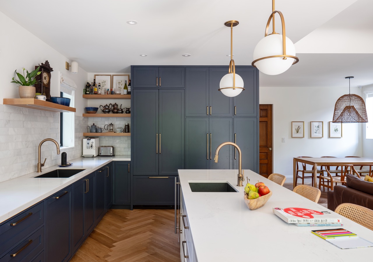 Rusholme Restored: Upstairs, statement botanical wallpaper anchors two bathrooms finished with white oak vanities, farmhouse sinks, and brass fixtures, while a third bath keeps things bright with subway tile, a freestanding oval tub, and floating…