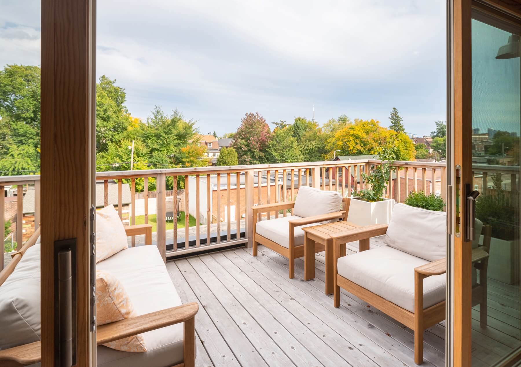 Dufferin Grove: A vaulted third floor contains the master bedroom and bathroom with a cozy library/lounge that walks out to the third floor deck - revealing views of the downtown skyline
