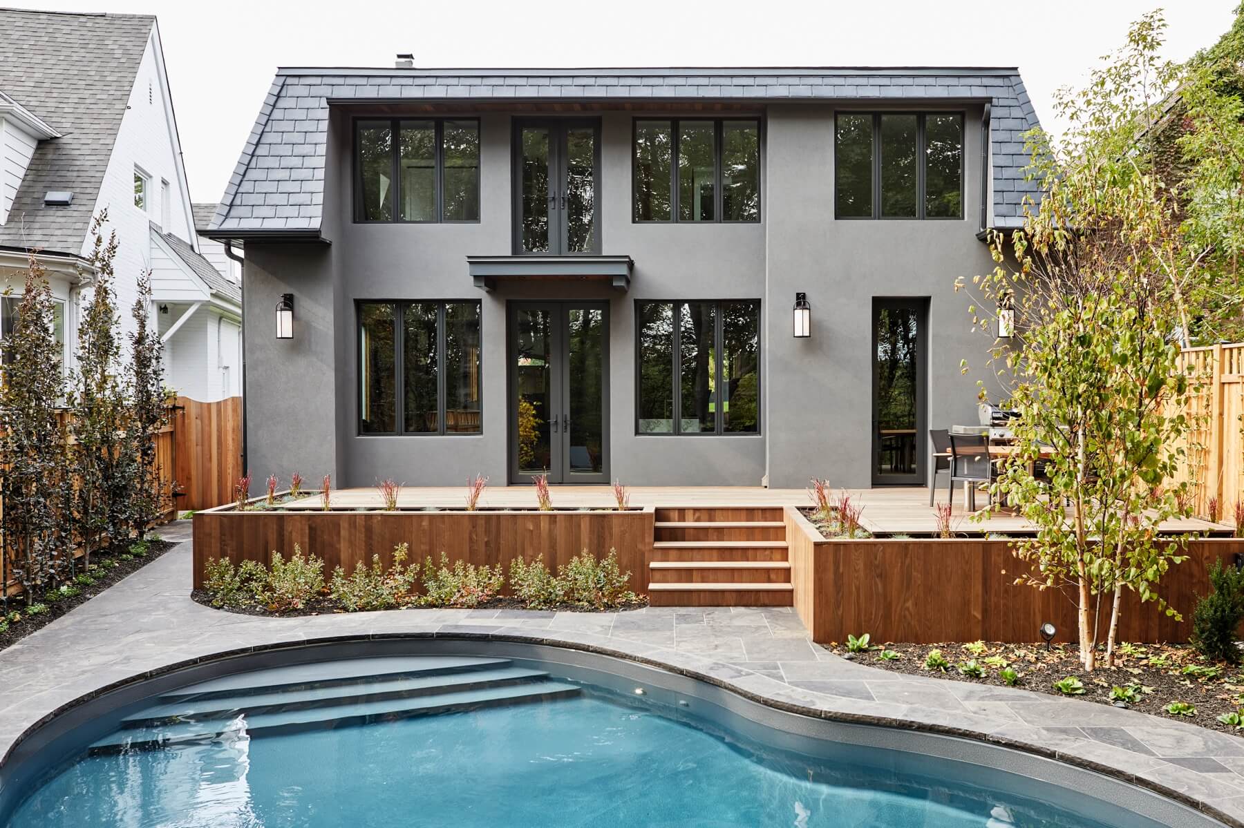 Islington Village: In keeping with the French style, a metal and slate mansard roofline dominates the façade, while inside, an open concept main floor split across three elevations, is punctuated by reclaimed rough hewn fir beams and a herringbone…