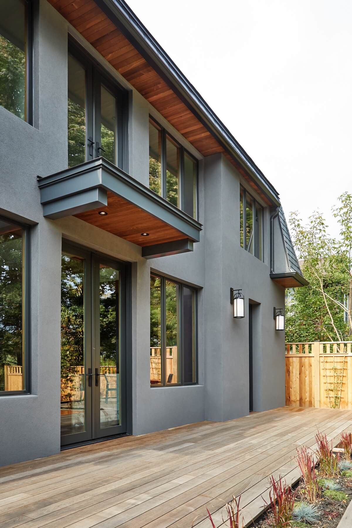 Islington Village: The emphasis on wood detailing continues with Pella fir windows framing a full view of the canopy of trees that hang over the golf course and back of the house