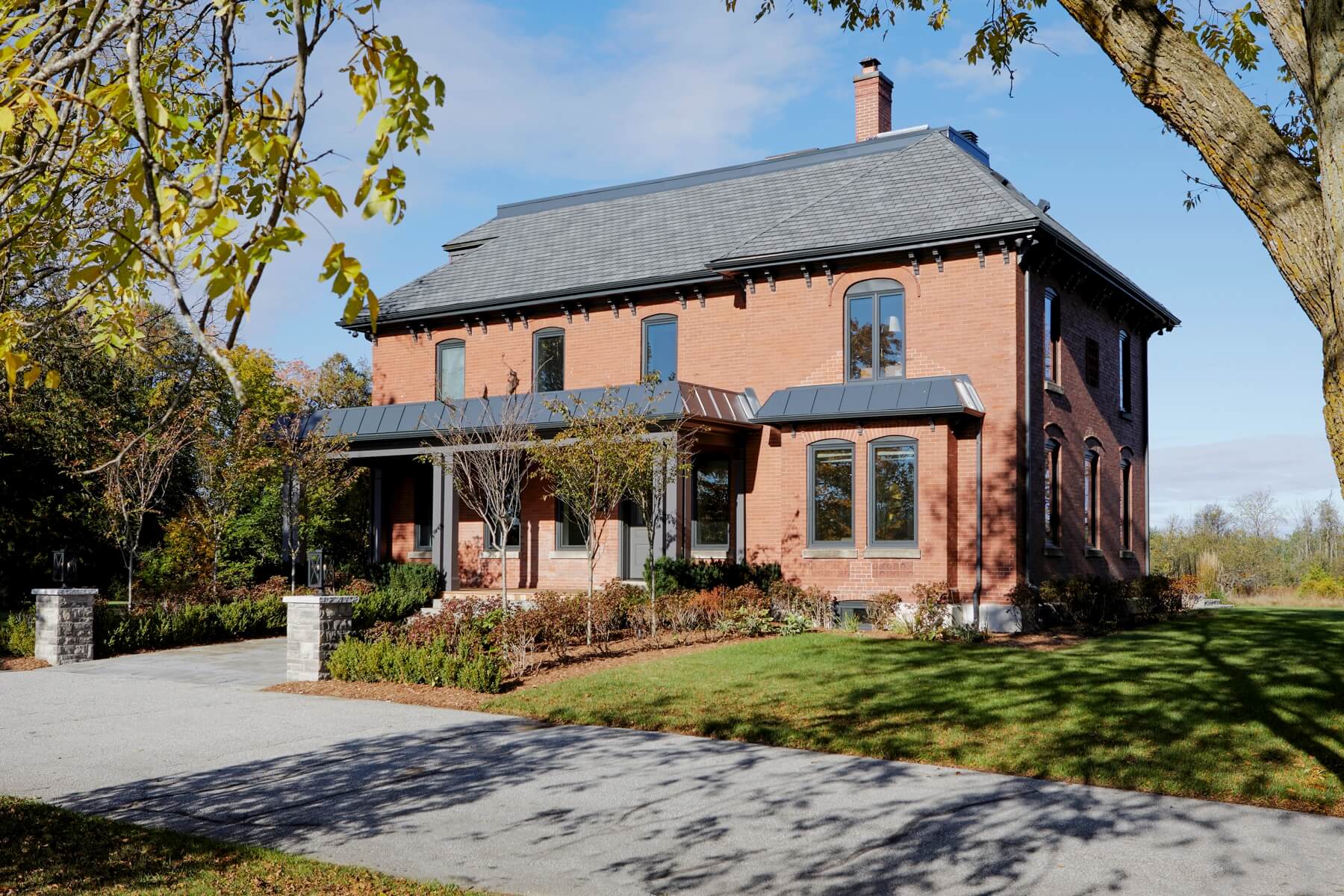 Manor Estate: The red-brick exterior façade showcases windows that assure plenty of light