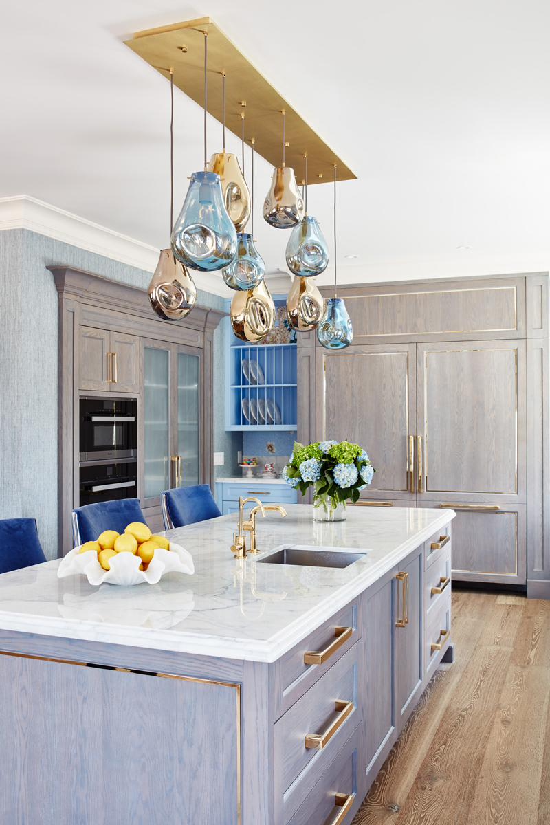 Manor Estate: The anything but understated kitchen makes a whimsical impression, featuring marble counters and backsplashes, cherry blossom mosaic tiling, powder blue custom cabinetry and metallic finishes of silver, brass, copper and rose gold