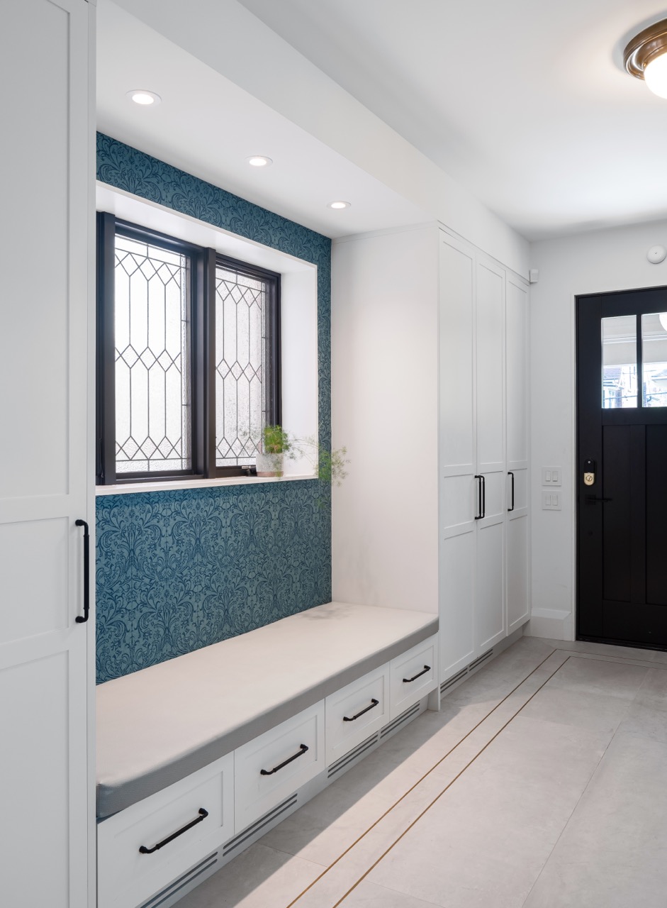 Picturesque Parkside: The exterior kept its dark gabled roofline, wraparound porch, and brick facade intact, while the interior was reimagined around a moody charcoal kitchen with a white oak island, subway tile hood surround, and full-height…