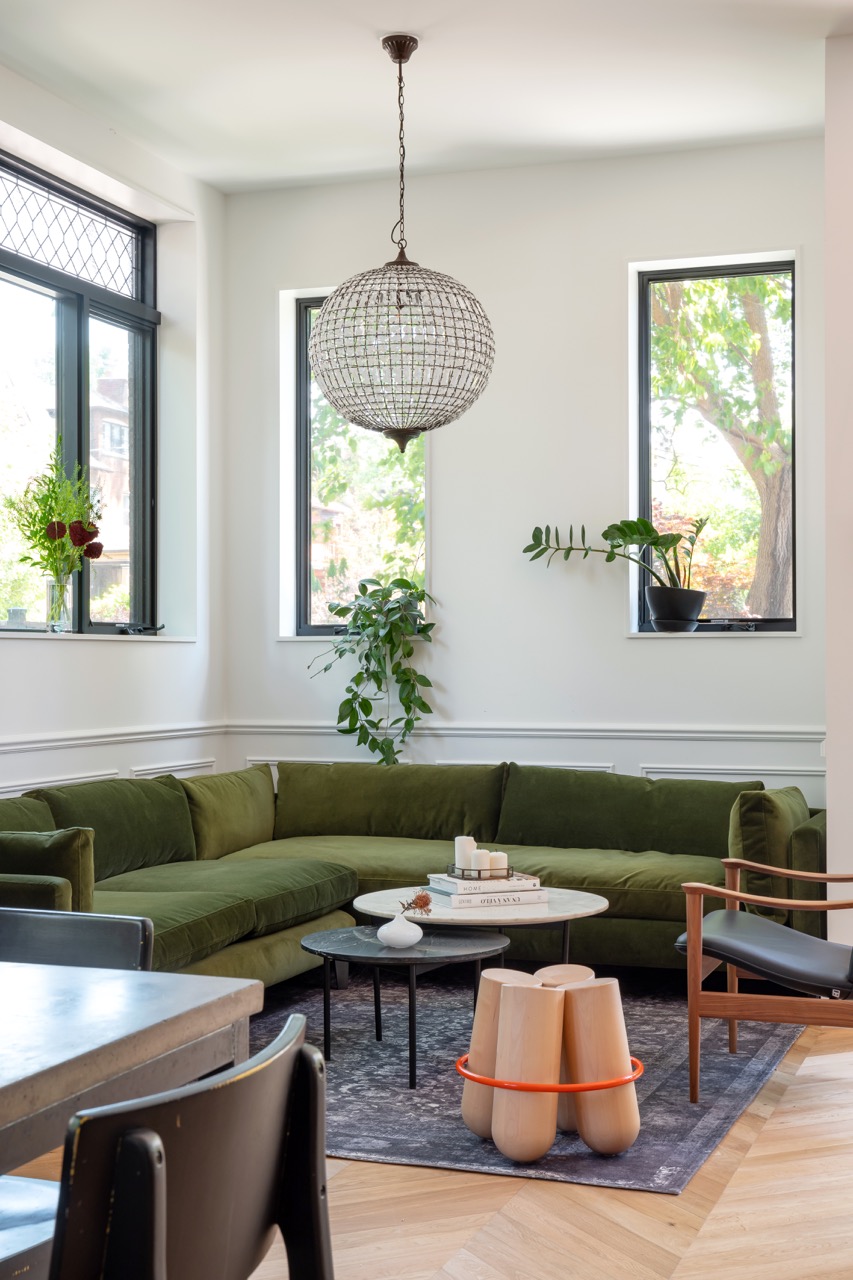 Picturesque Parkside: The exterior kept its dark gabled roofline, wraparound porch, and brick facade intact, while the interior was reimagined around a moody charcoal kitchen with a white oak island, subway tile hood surround, and full-height…