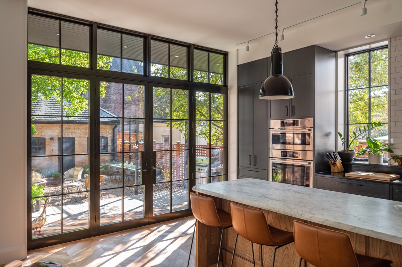 Picturesque Parkside: Black steel-framed glass doors divide the principal rooms without closing them off, and brass flush-mounts add warmth throughout