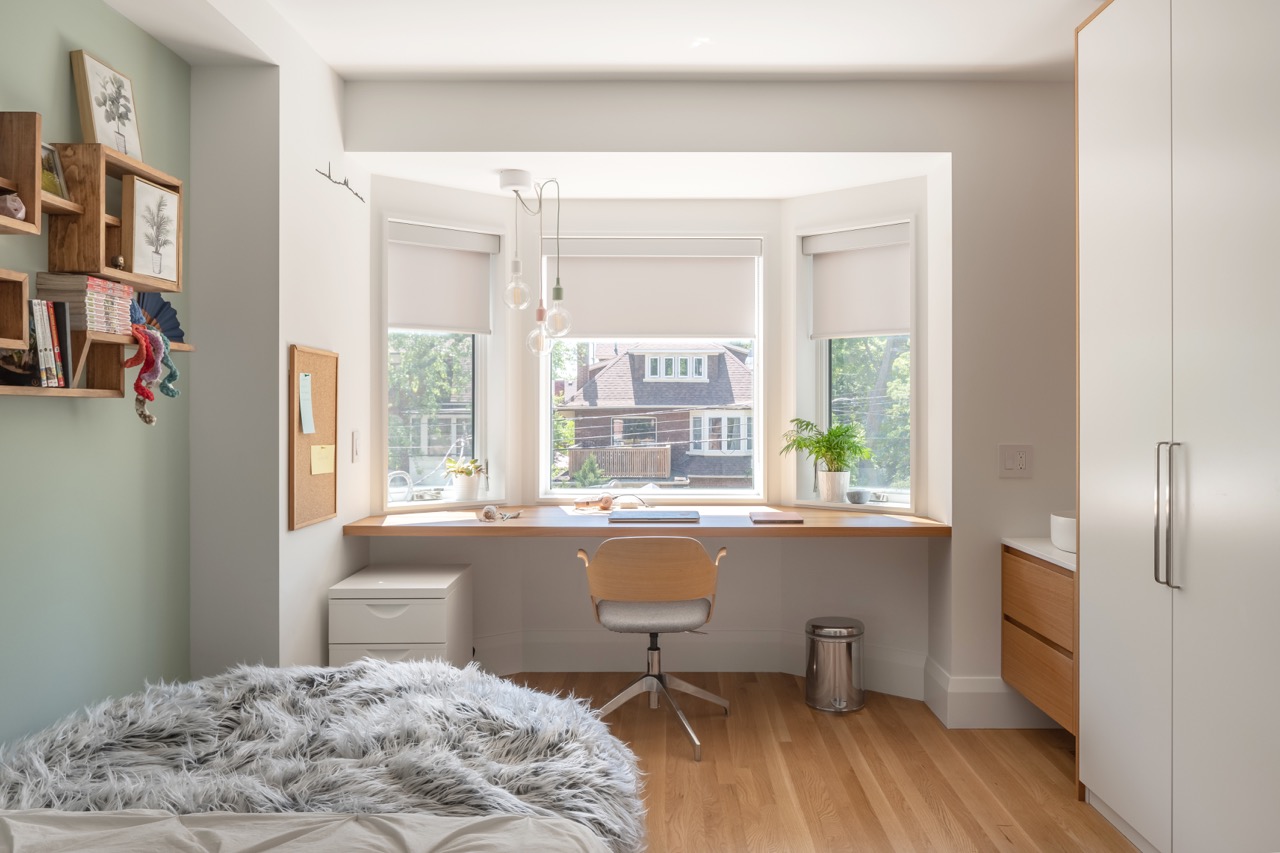 Picturesque Parkside: The exterior kept its dark gabled roofline, wraparound porch, and brick facade intact, while the interior was reimagined around a moody charcoal kitchen with a white oak island, subway tile hood surround, and full-height…
