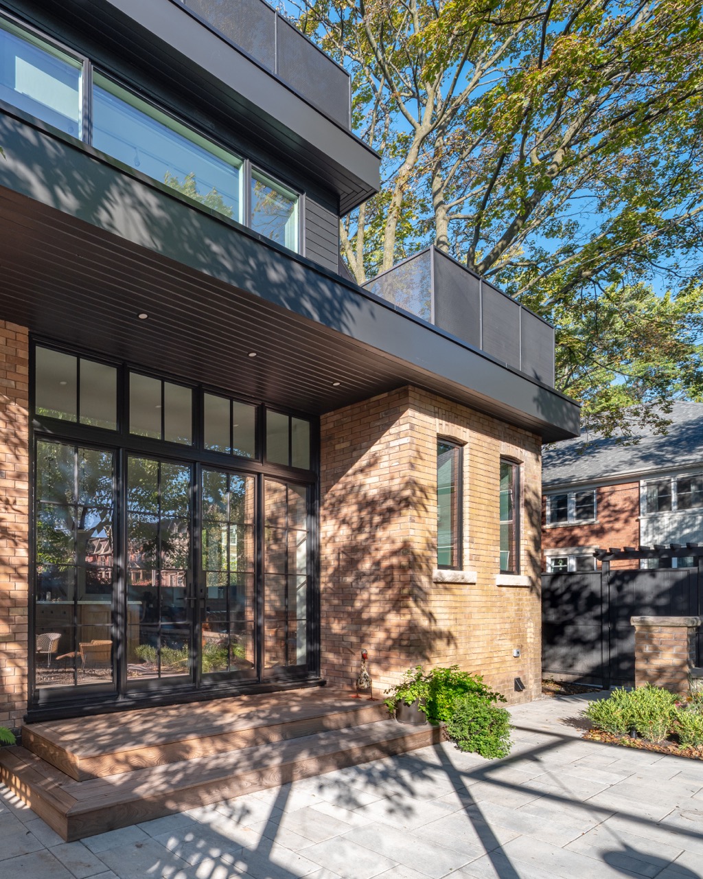Picturesque Parkside: Black steel-framed glass doors divide the principal rooms without closing them off, and brass flush-mounts add warmth throughout