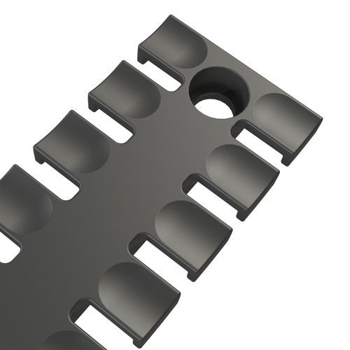 Dark grey, rectangular cable entry with several half-round openings and one round opening
