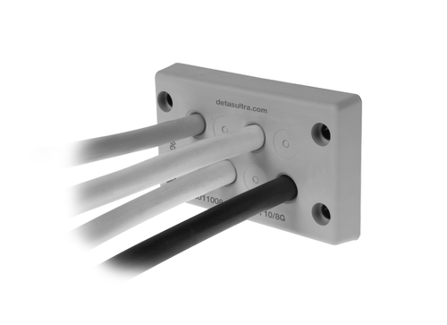 Grey rectangular cable entry plate with four cables fed through in white, grey and black