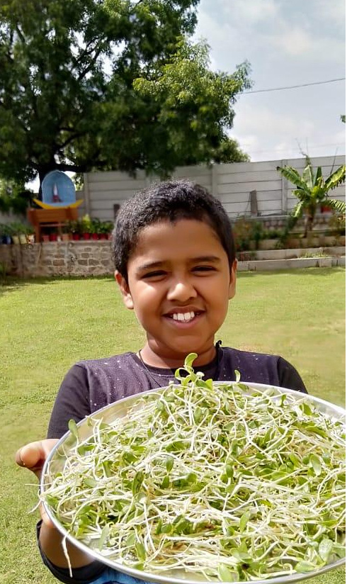 kid shows his farming poduce