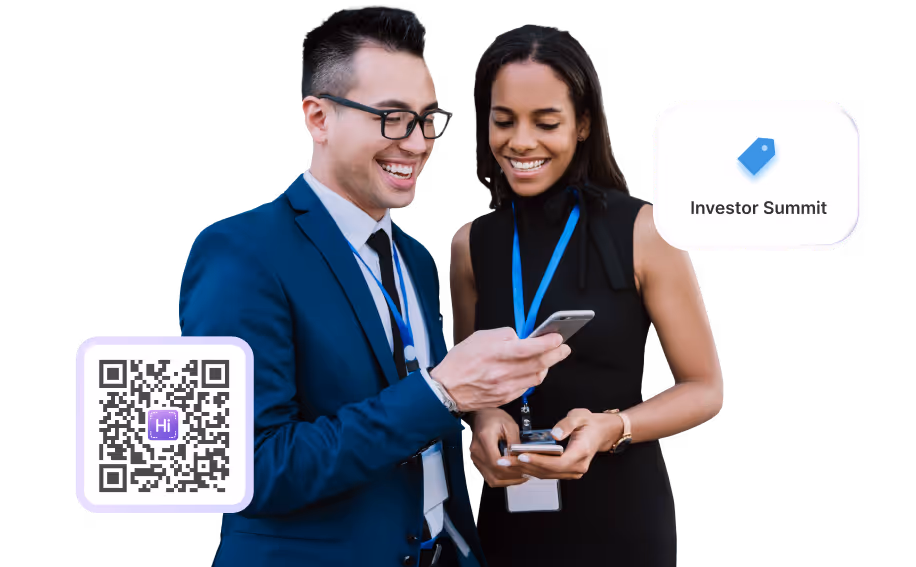 Two professionals at a conference sharing digital business cards using HiHello.