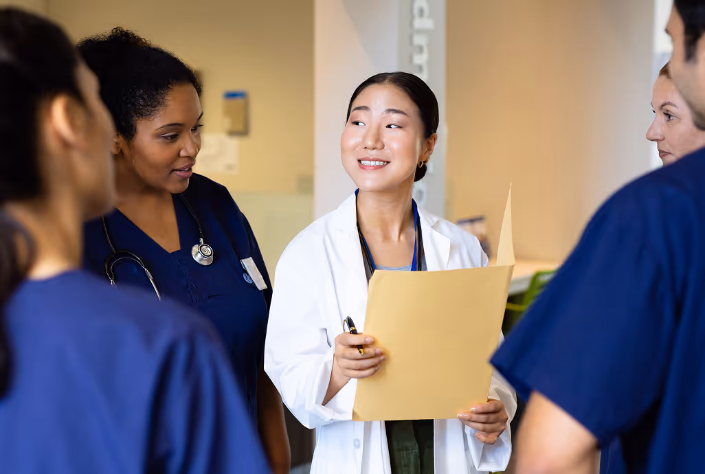 Medical staff reviewing chart representing hospitals and clinics adopting HiHello digital business cards