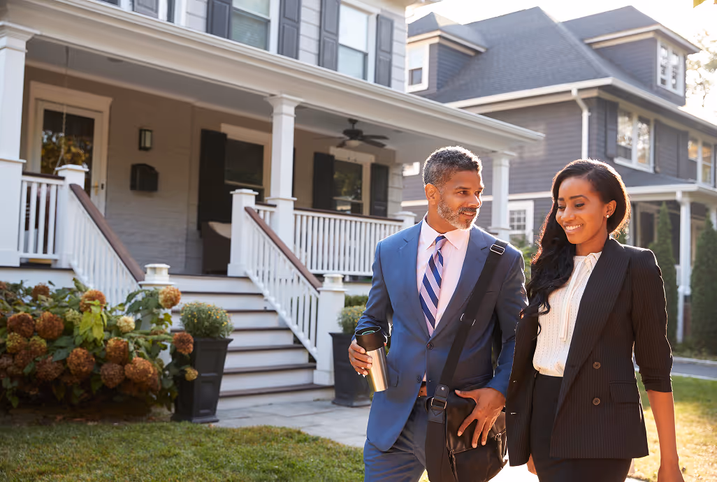 Real estate agents showing a home to clients representing brokerages adopting HiHello
