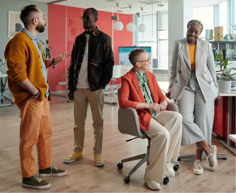 Marketers talking and working together in a bright colorful modern office setting
